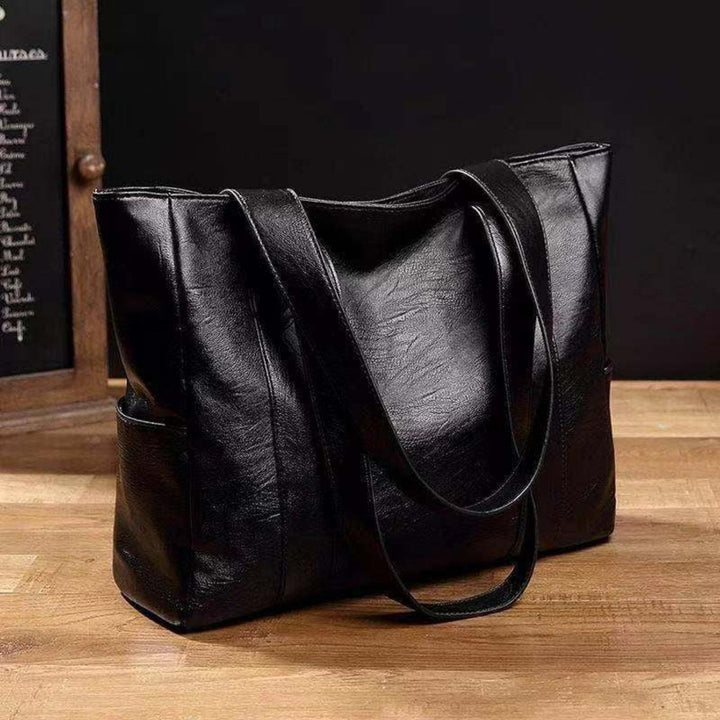 Versatile black leather shoulder bag for women, a stylish vintage tote and classic everyday fashion accessory.