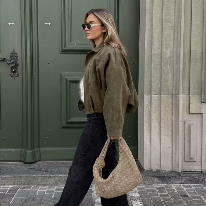 Back view: Women's oversized bomber jacket, highlighting comfortable, casual layering style outerwear.