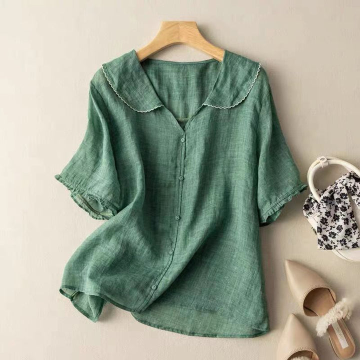 Women's vintage style blouse with chic button detail, long sleeves, and elegant design, perfect for sophisticated wear.