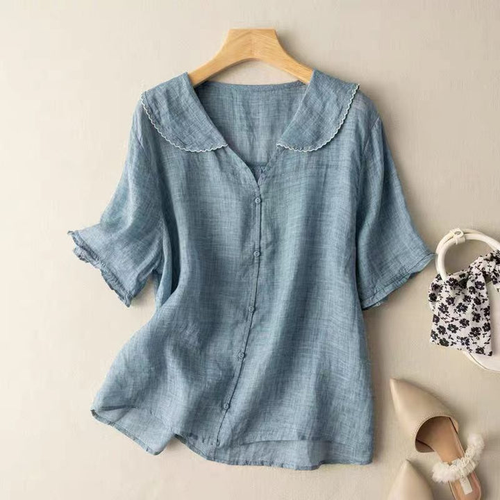 Comfortable and versatile women's vintage blouse, featuring chic button detail and long sleeves for casual elegant wear.