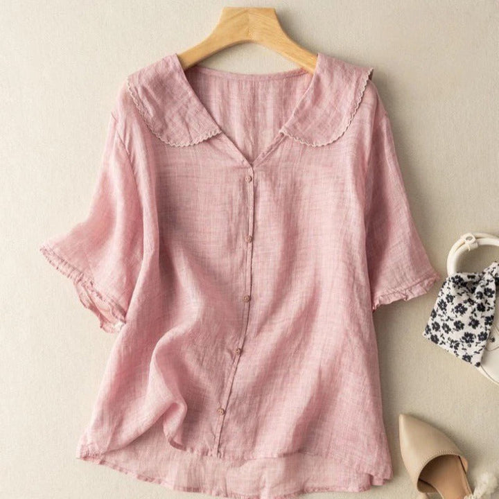 Classic fashion women's long sleeve blouse with sophisticated vintage style and chic button detailing. Feminine top.