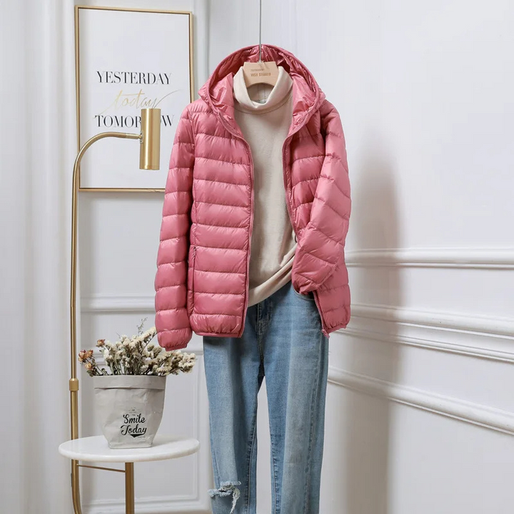 Women's warm hooded puffer jacket with zip-up style, perfect for cold weather.