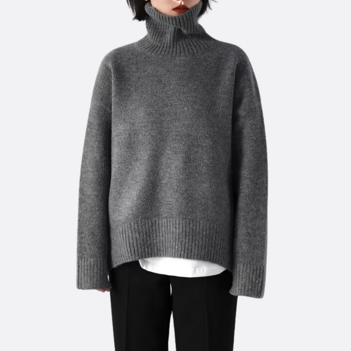 Cozy women's warm knit oversized turtleneck sweater for ultimate comfort in cold weather. Long sleeve design.