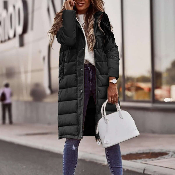 Stylish quilted women's long padded winter coat with a hood, ensuring warmth and fashion.