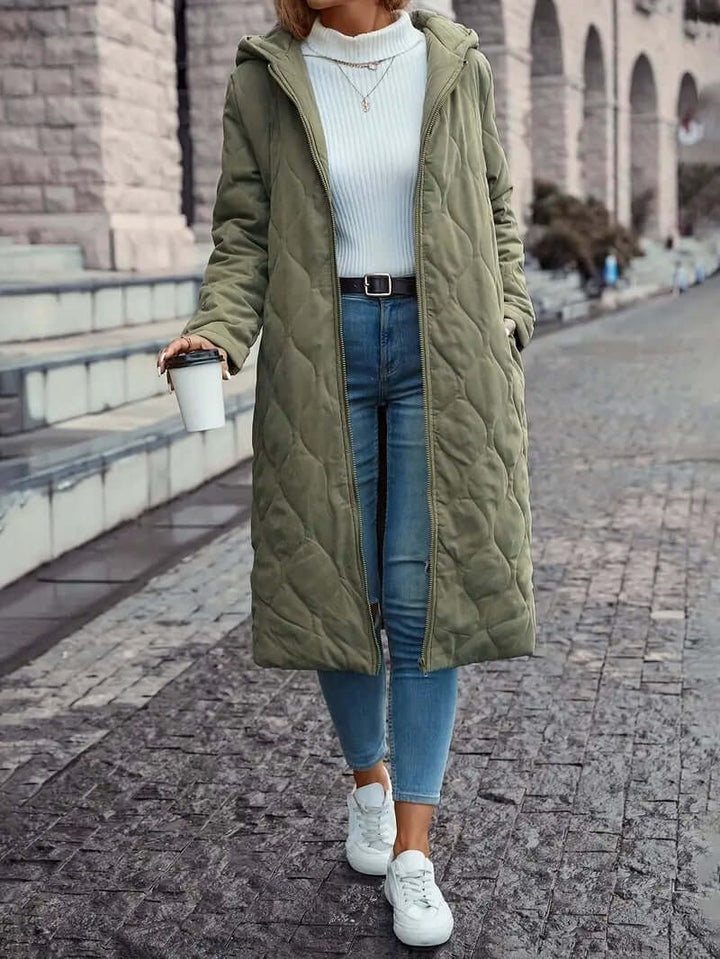 Cozy women's insulated down puffer coat with hood. Ideal warm winter jacket for cold weather fashion.