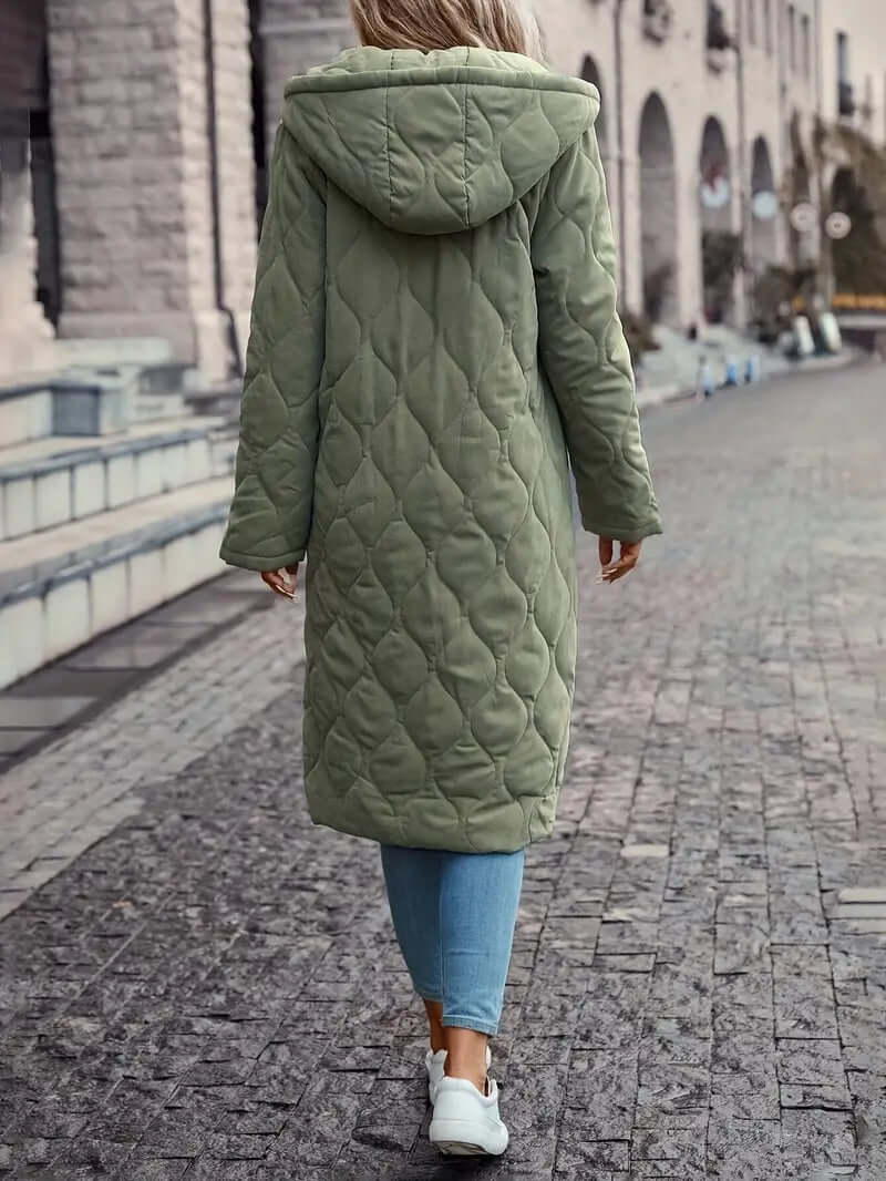 Stylish women's hooded quilted down puffer coat. Warm and cozy insulated winter jacket for outdoor activities.