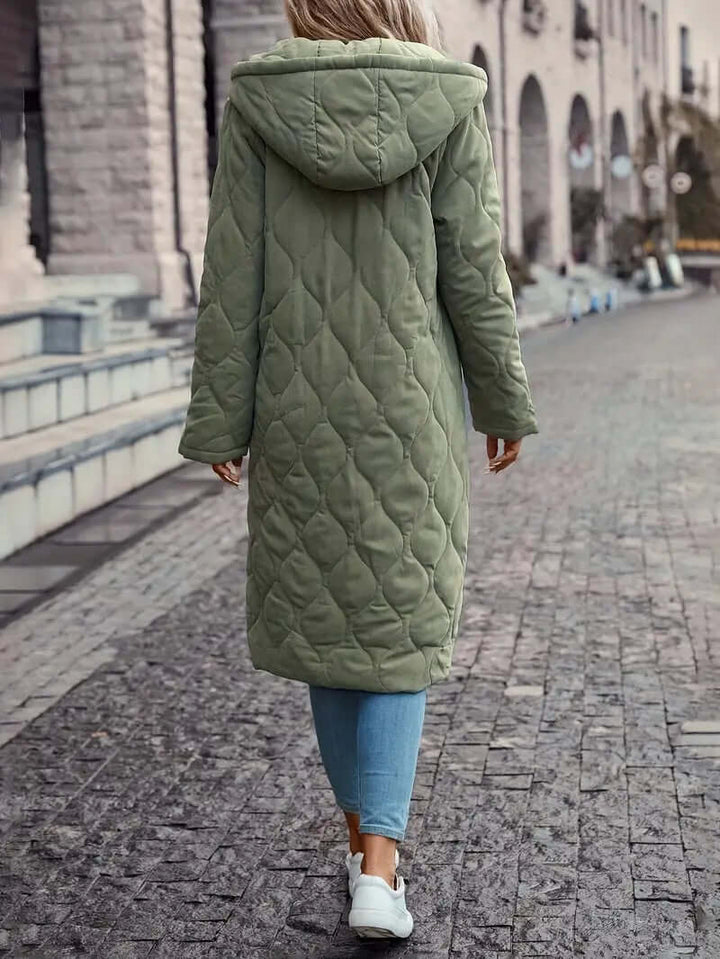 Stylish women's hooded quilted down puffer coat. Warm and cozy insulated winter jacket for outdoor activities.