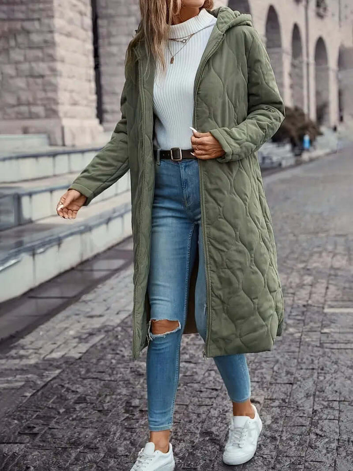 Warm women's down-filled quilted coat with hood. Essential winter puffer jacket, cozy insulated outerwear.
