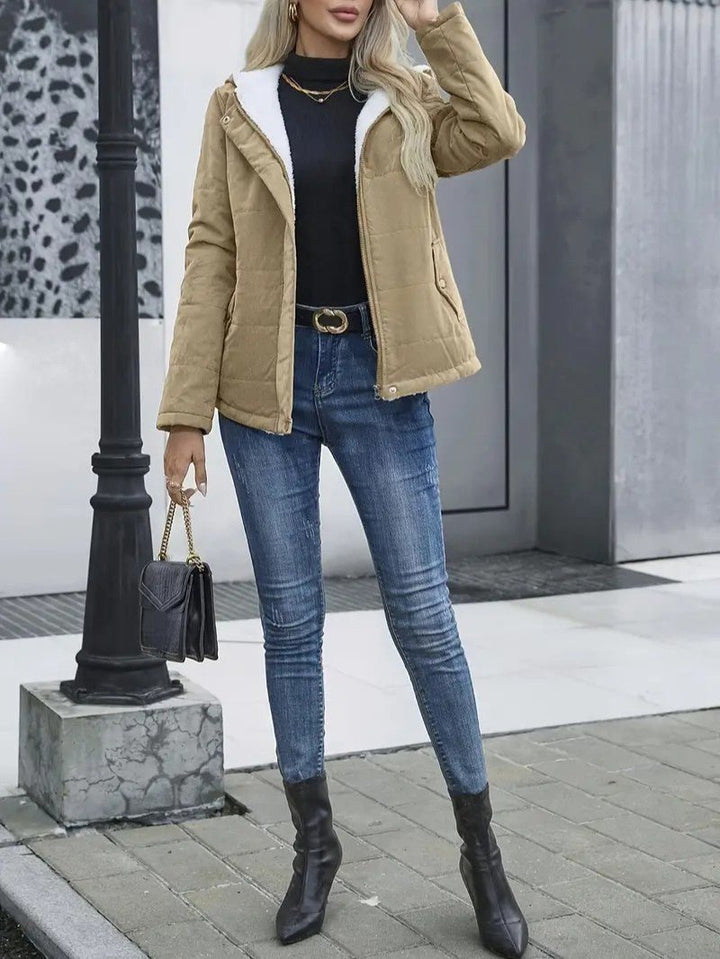 Durable women's cold weather hooded jacket with zip closure, insulated for warmth.