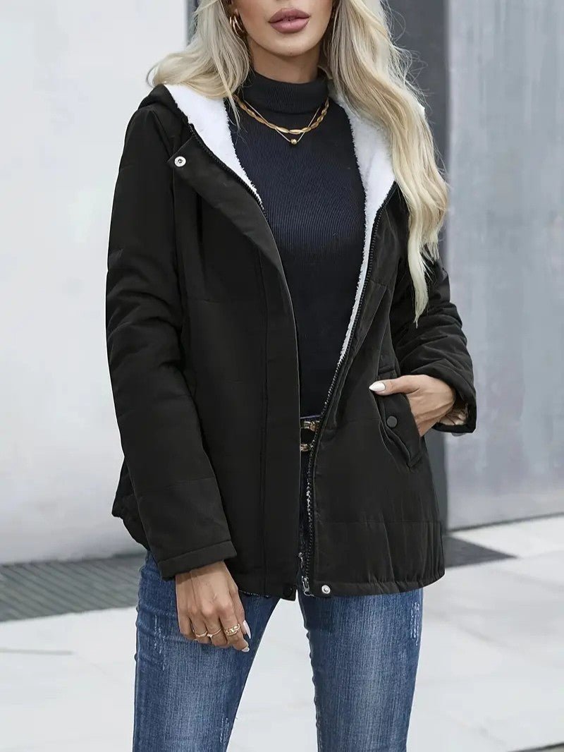 Women's sleek zip-up hooded jacket, warm and versatile for winter activities.