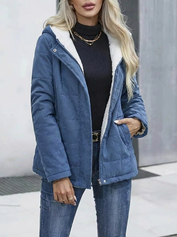 Stylish women's zip-up hooded jacket, ideal outerwear for winter adventures.