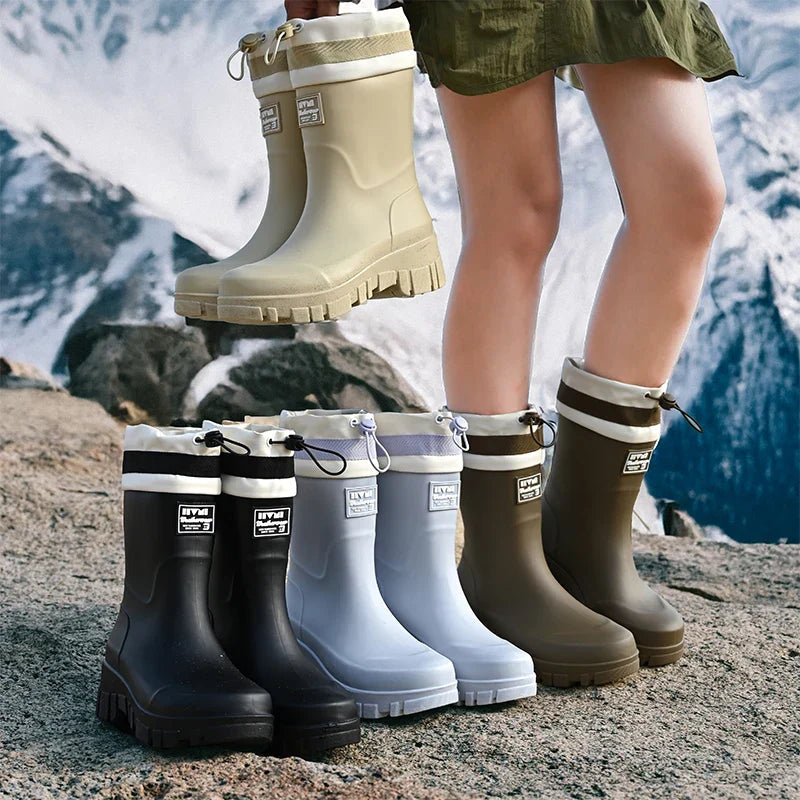 Waterproof women's mid-high rain boots, durable and slip-on for versatile outdoor wear.