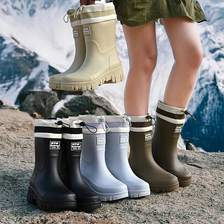 Waterproof women's mid-high rain boots, durable and slip-on for versatile outdoor wear.
