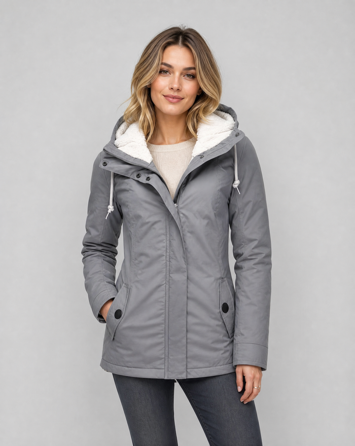Women's waterproof rain jacket with hood, ideal for all-weather protection and style.