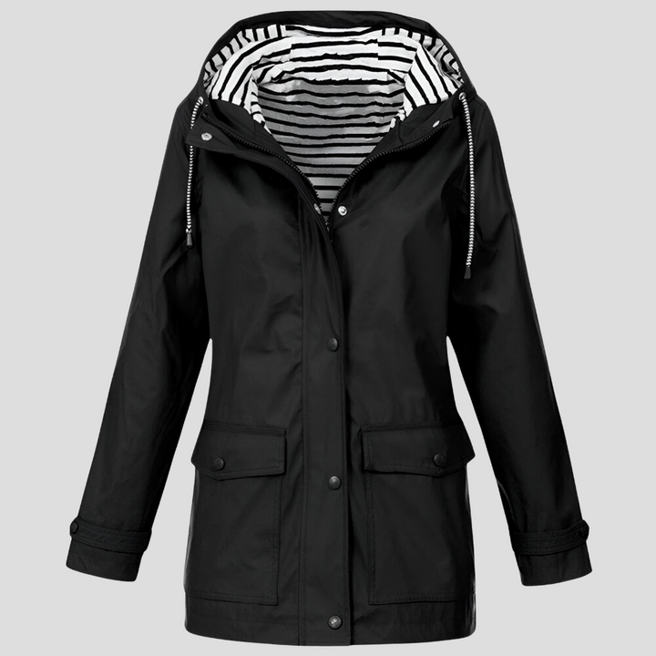 Lightweight women's hooded rain jacket, side view, showing weatherproof design for active outdoor autumn travel.