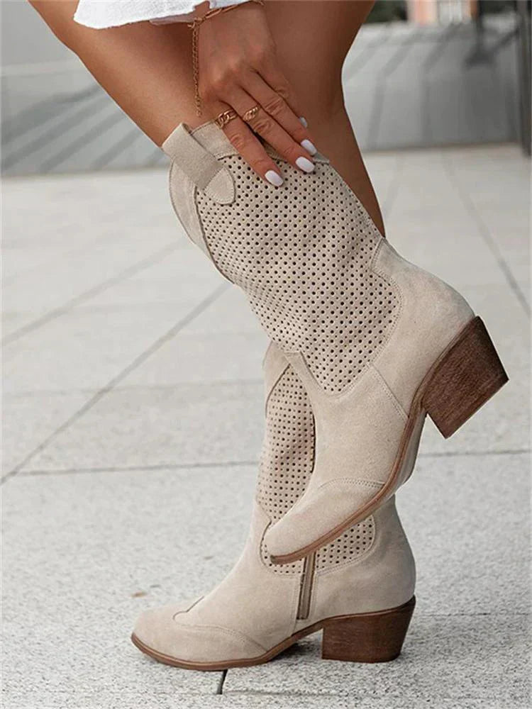 Stylish women's Western ankle boots with pointed toe and block heel. Faux leather pull-on design.