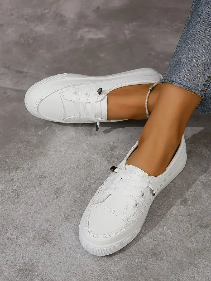 Women's white casual lace-up flat sneakers, perfect for everyday wear and comfort. Versatile round toe design.