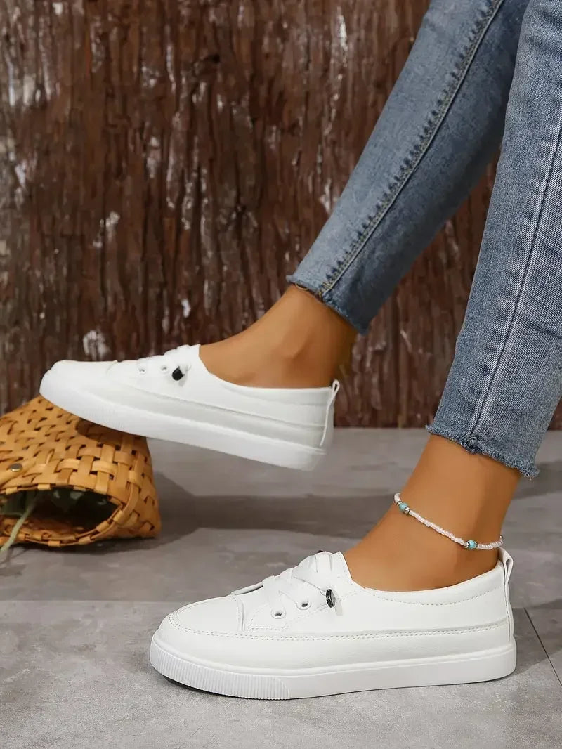 Stylish women's flat lace-up sneakers, casual white design with a comfortable round toe for everyday fashion.