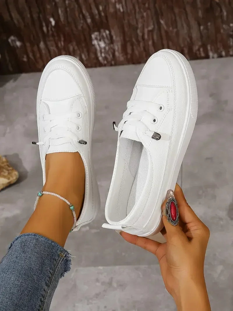 White casual lace-up flat sneakers for women, designed for all-day comfort and versatile everyday styling.