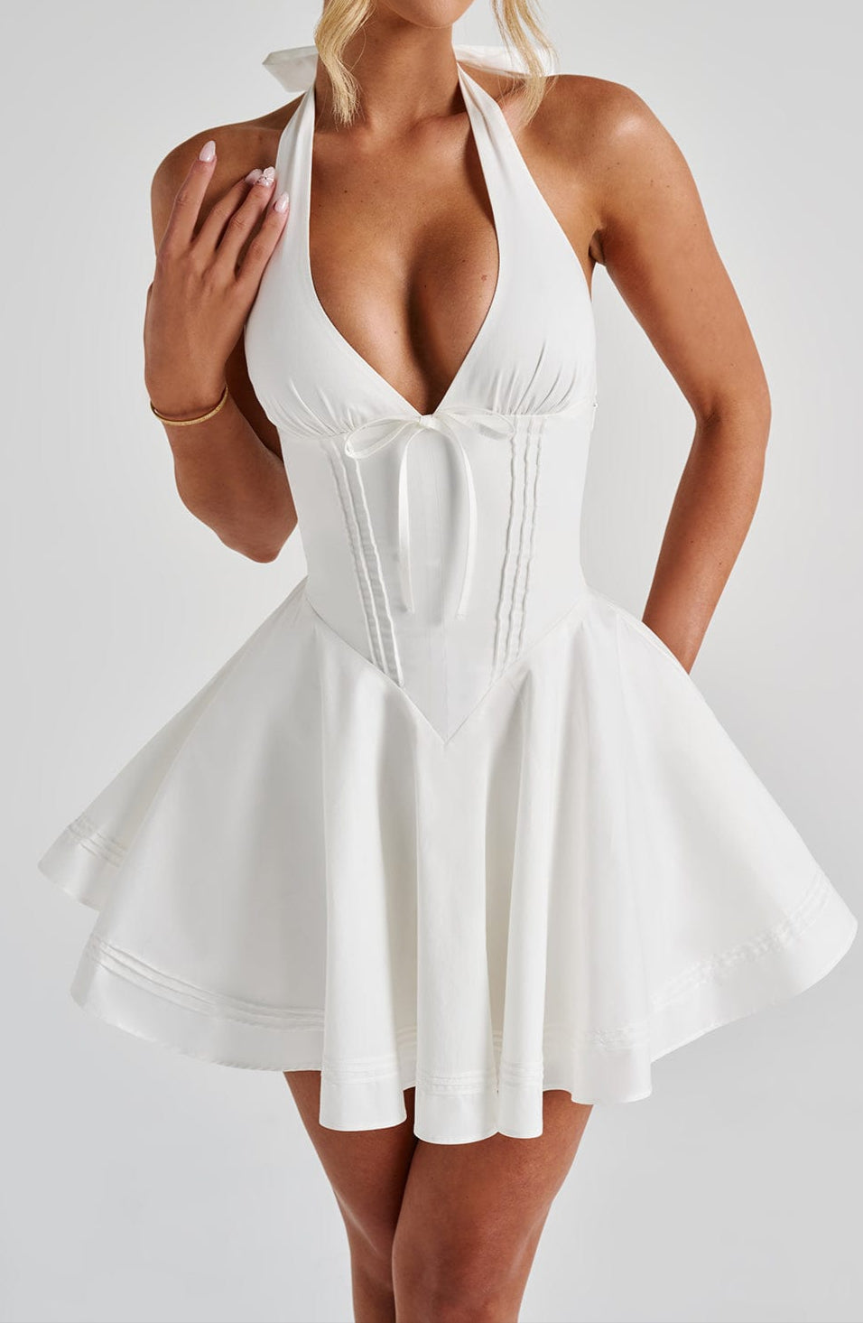 Trendy women's white mini dress, a summer fashion essential with a flattering halter neck.