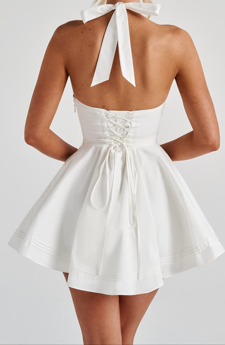 Effortless white mini cocktail dress for women, with a modern halter neck & sleeveless design.