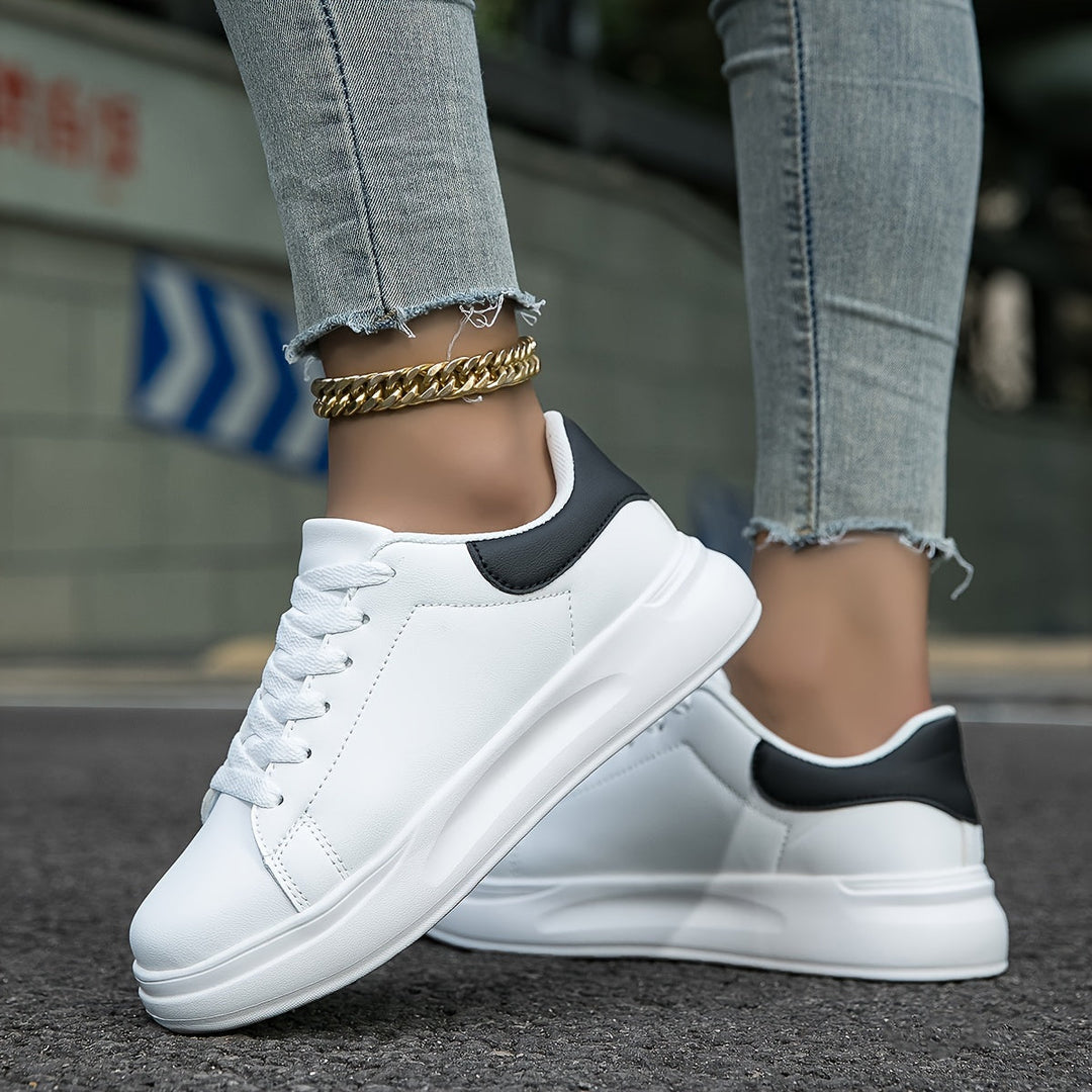 Front view of new women's white lace-up sneakers, ideal for minimalist style & comfortable walking.