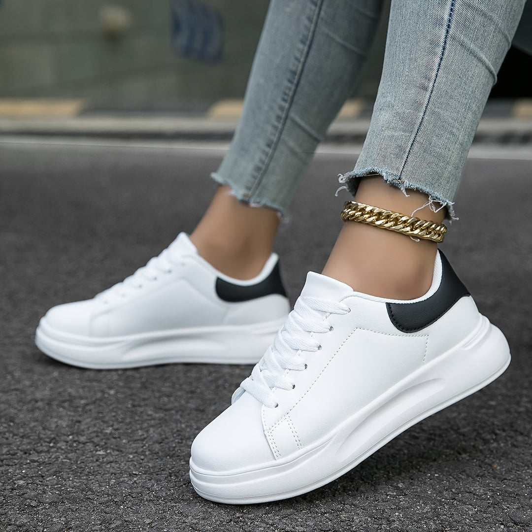Close-up of comfortable women's white sneakers, showcasing material quality for versatile everyday wear.
