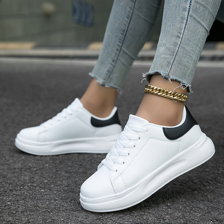 Close-up of comfortable women's white sneakers, showcasing material quality for versatile everyday wear.