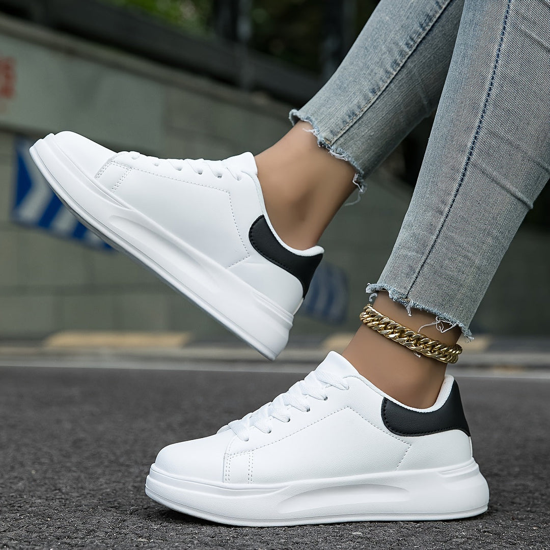 Woman wearing stylish white sneakers, perfect for casual outfits & comfortable all-day walking.
