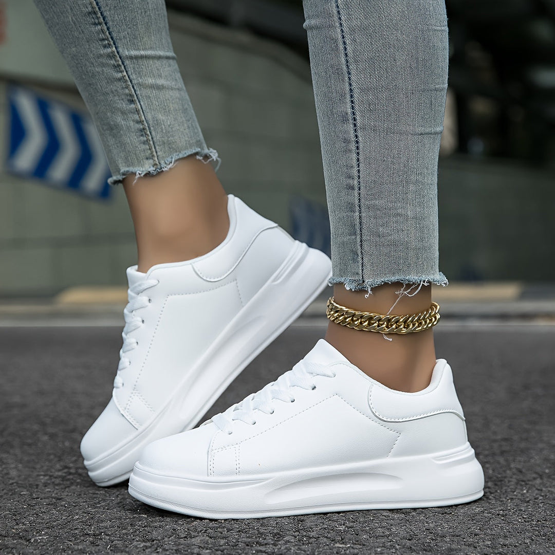 Durable sole of women's white sneakers, providing comfort & grip for walking and everyday wear.