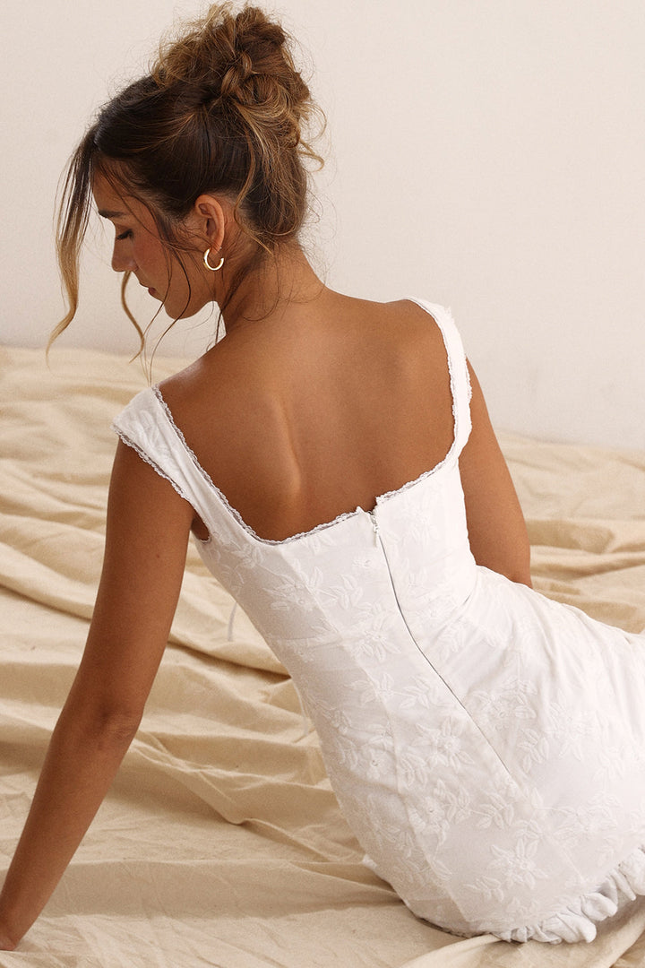 Versatile white mini dress for women featuring a chic tie waist. Great for summer fashion & parties.