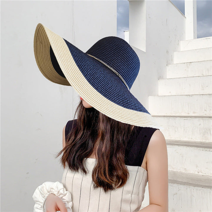 Women's wide brim sun hat with UV protection, perfect for beach days & stylish outdoor activities.