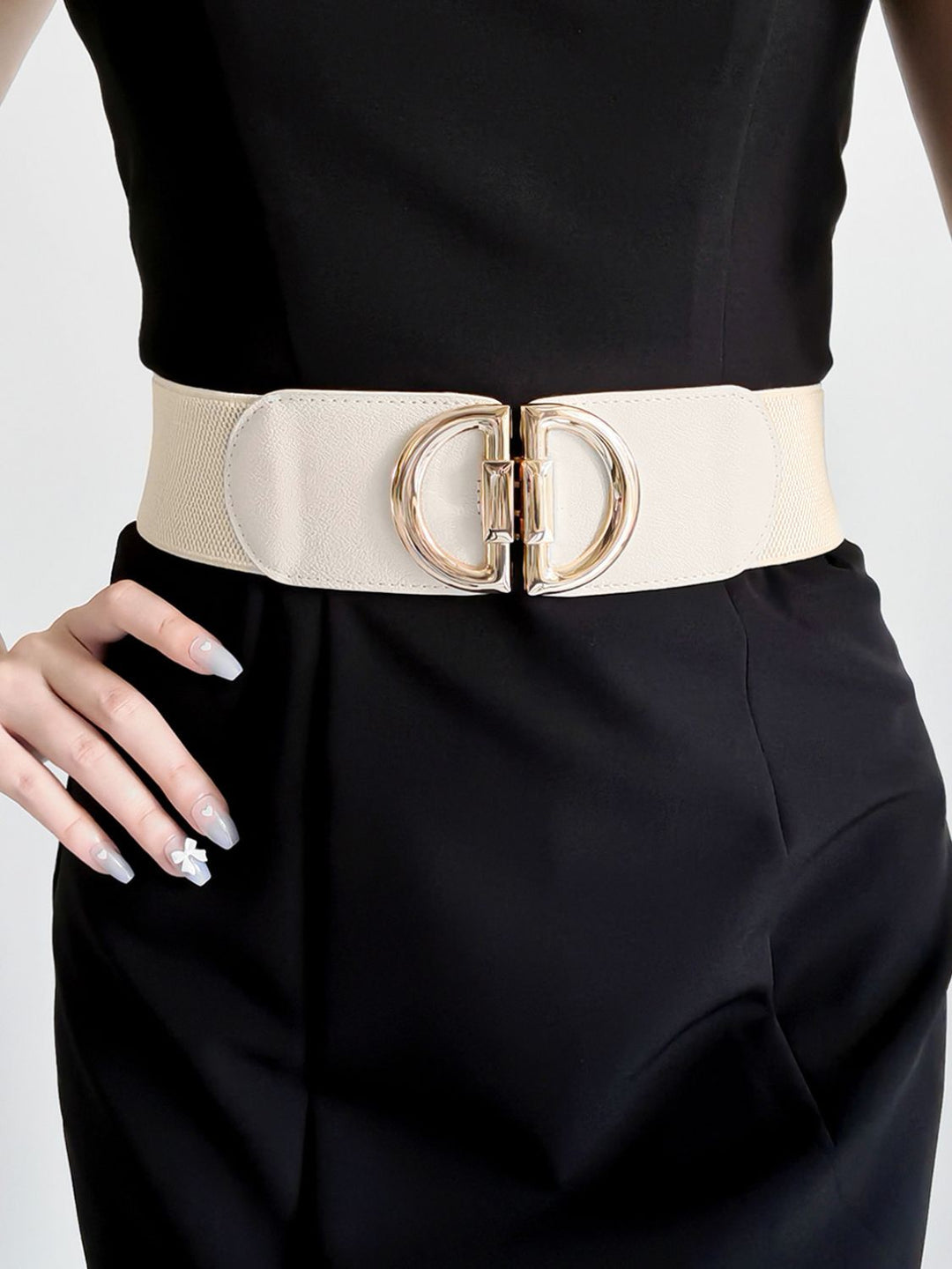 Women's wide elastic waist belt with intricate detailing on the stylish gold buckle.