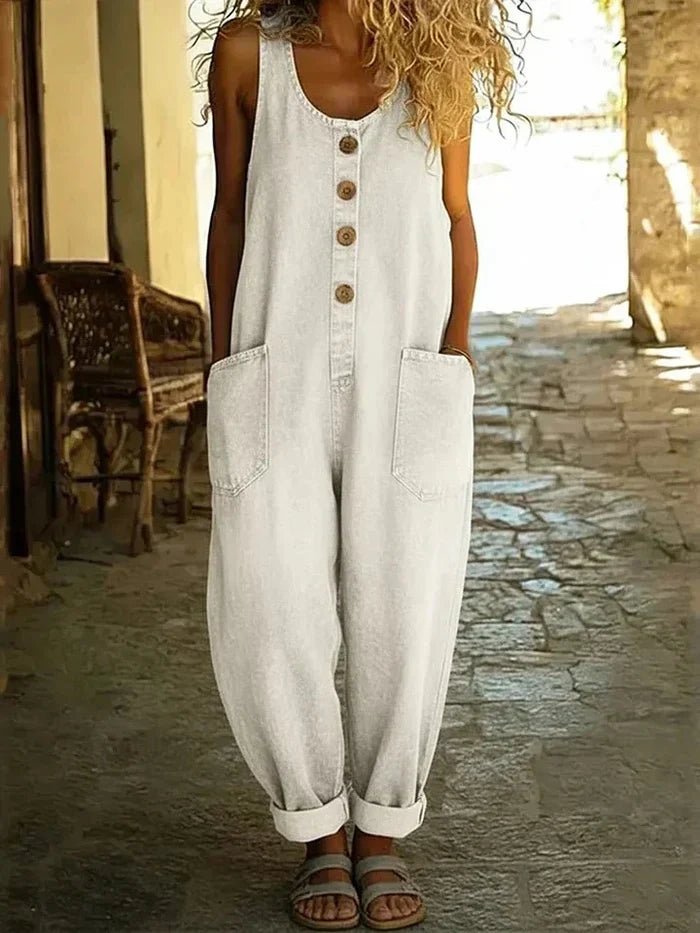 Sleeveless women's wide leg overalls, button-front, with pockets for a comfortable and stylish casual summer outfit.