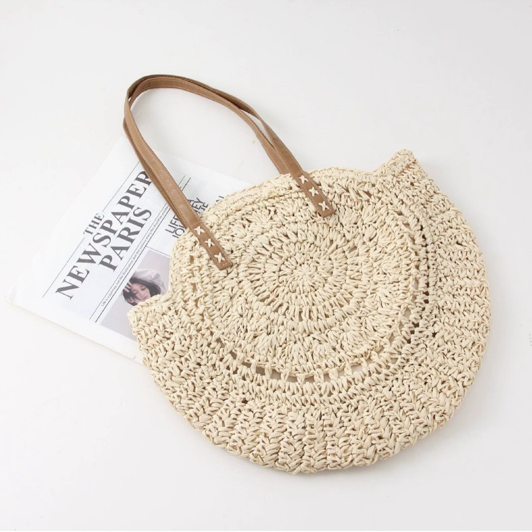 Women's woven round beach tote bag, perfect for summer fashion & resort wear. Stylish everyday shoulder bag.