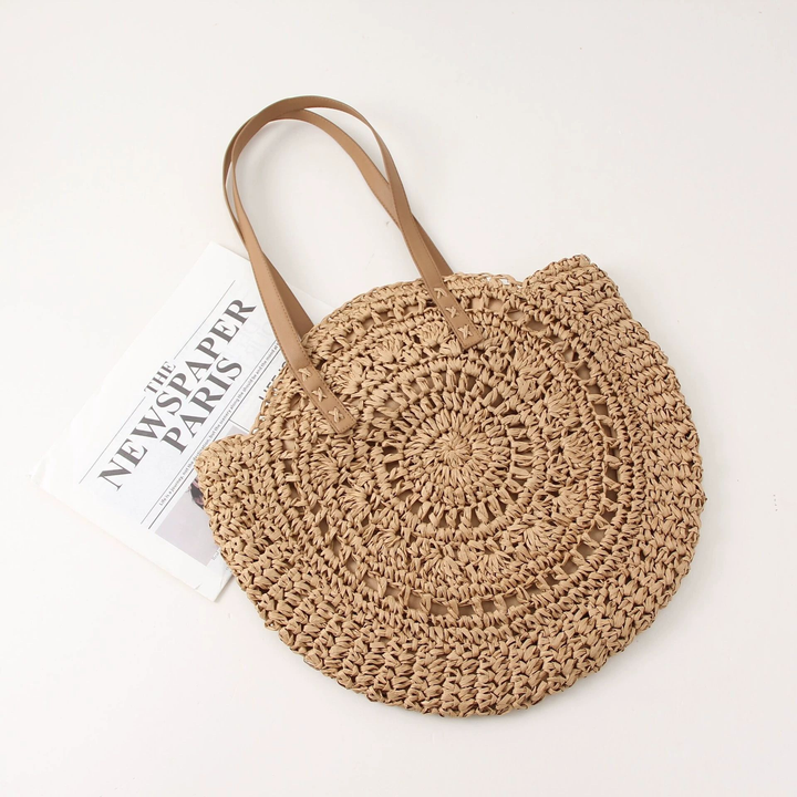 Chic women's round woven beach bag, a trendy summer fashion statement. Perfect as a shoulder tote for resort wear.