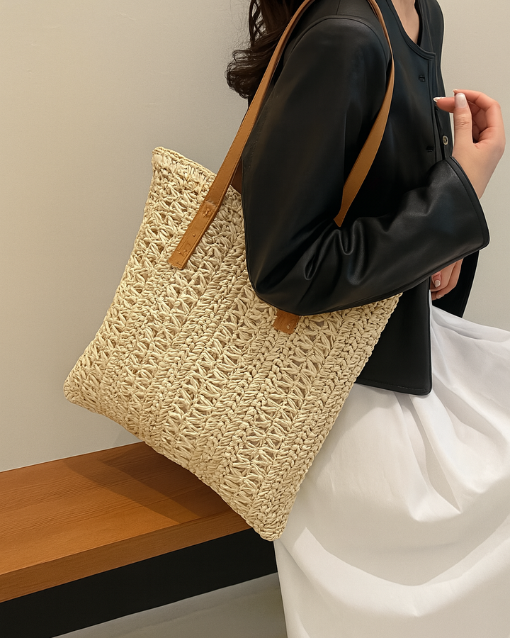 Stylish women's woven straw shoulder bag, ideal summer accessory, also functions as a spacious beach tote.