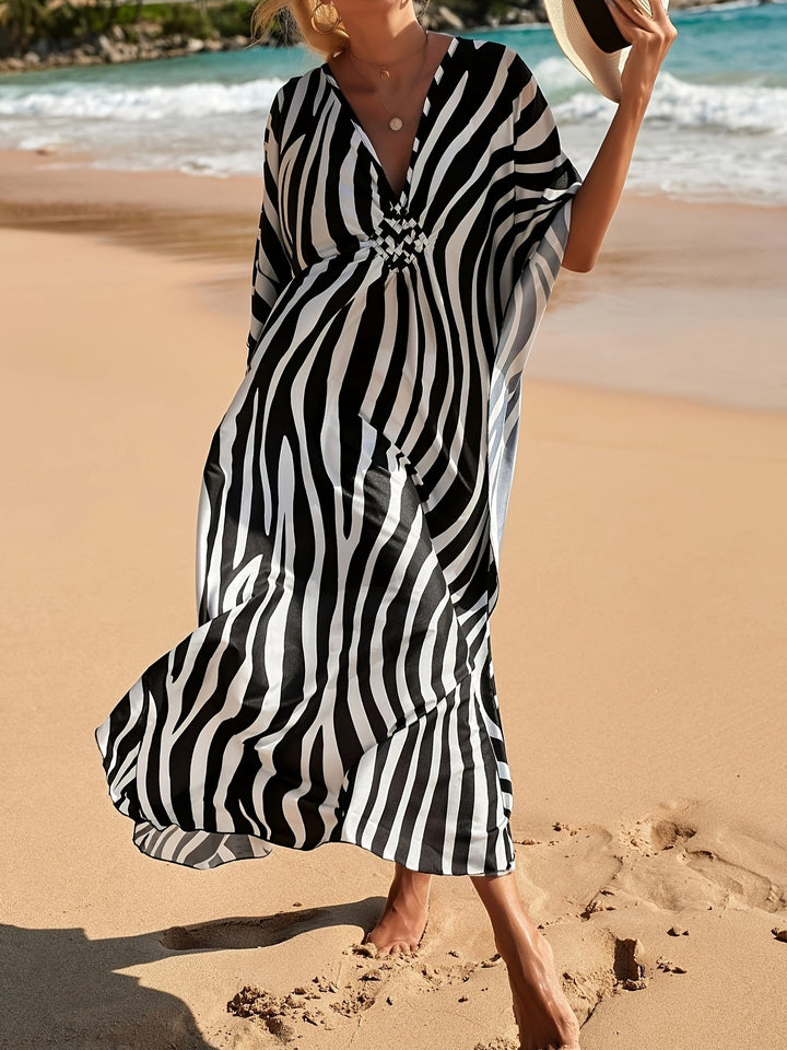 Vibrant zebra print V-neck maxi beach dress for women. Comfortable kaftan style resort wear, perfect for summer.