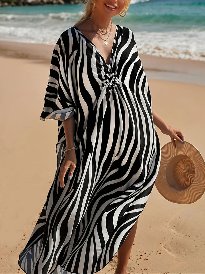 Flowy women's zebra print maxi beach dress with a flattering V-neck, great for summer fashion & resort vacations.