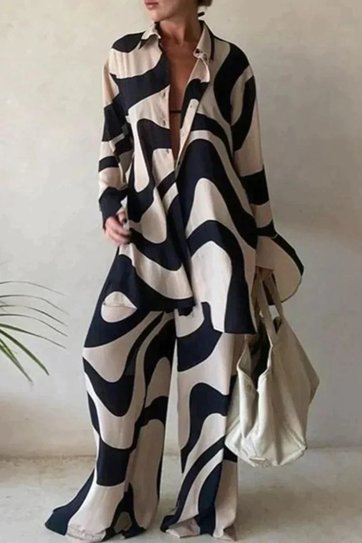 "Women's abstract printed 2-piece set with long-sleeve shirt and wide-leg pants, relaxed fit, bold pattern."
