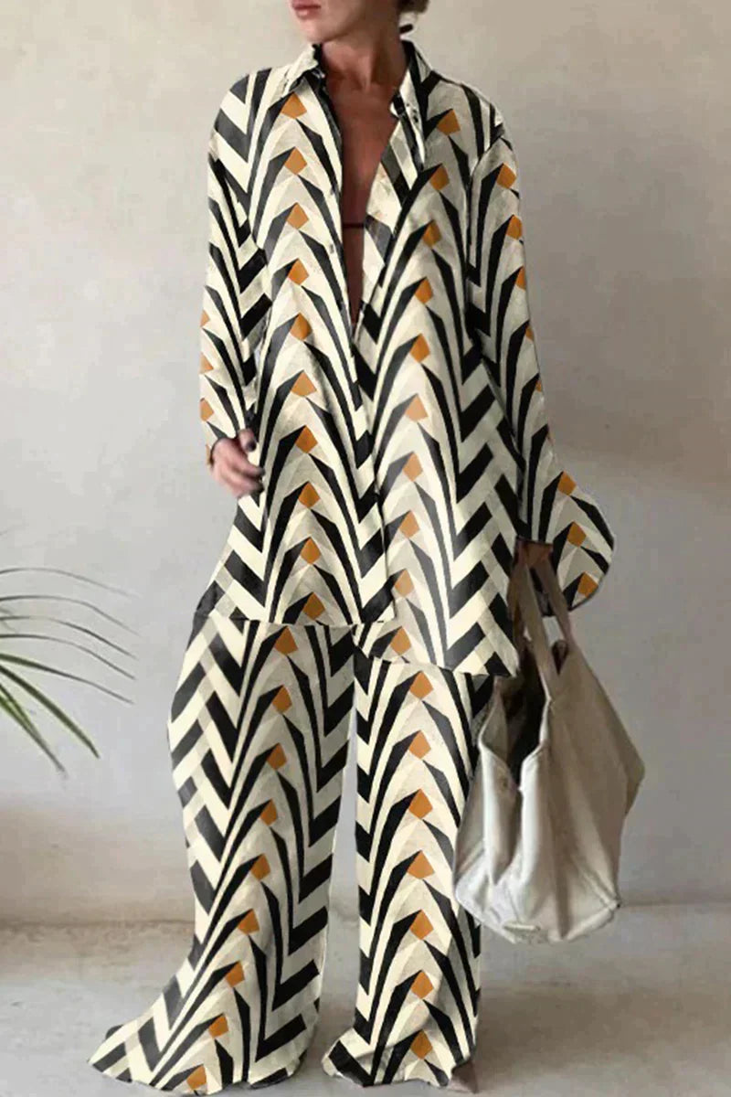"Women's abstract printed 2-piece set with long-sleeve shirt and wide-leg pants, relaxed fit, bold pattern."