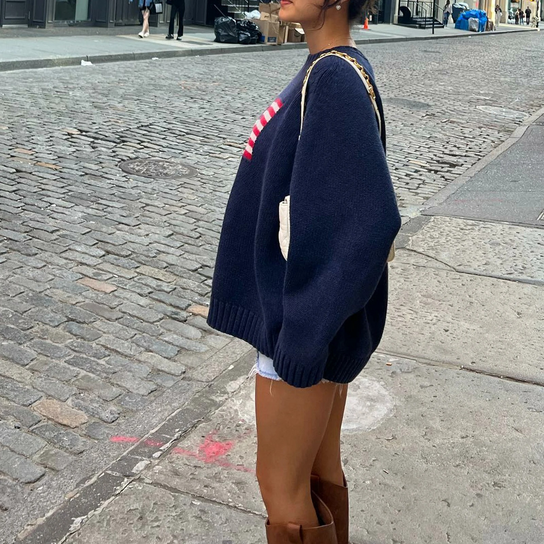 Women's blue sweater with American flag print, featuring relaxed fit and vibrant design for stylish, casual wear.