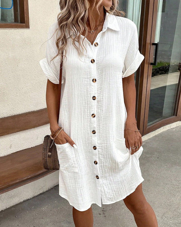 "Women's cotton blend shirt dress with button-down front, short sleeves, and rolled cuffs for casual elegance - front view."