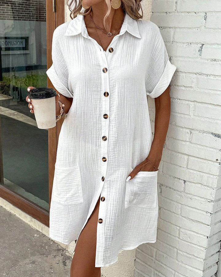 "Women's cotton blend shirt dress with button-down front, short sleeves, and rolled cuffs for casual elegance - front view."