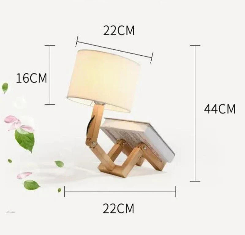 Adjustable wooden robot lamp for reading, with a handy book holder. Perfect unique lighting for desks.