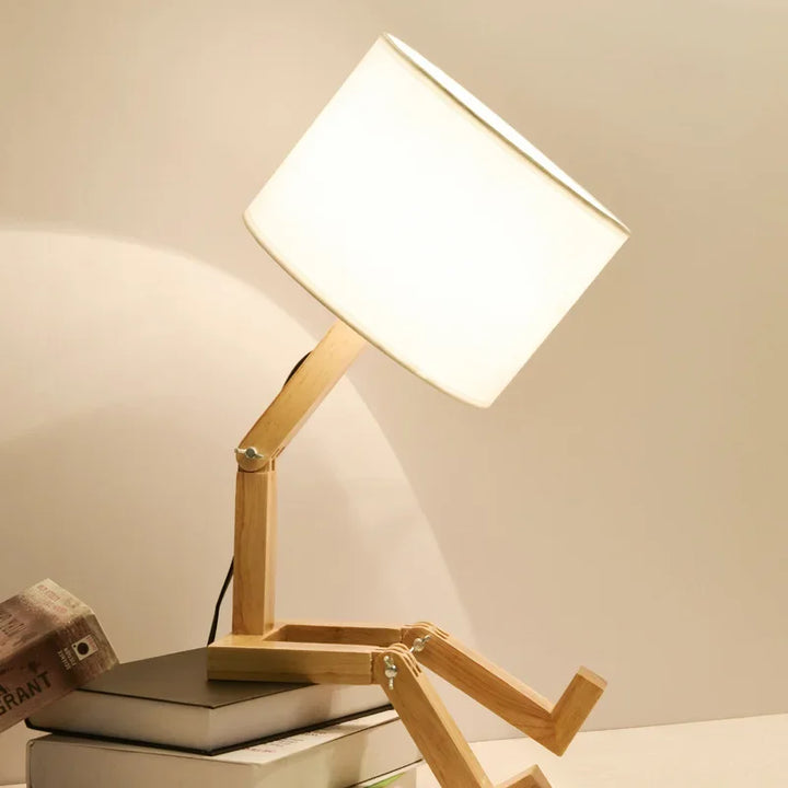 Practical wooden table lamp, robot-inspired, provides light and a sturdy book holder for your desk.